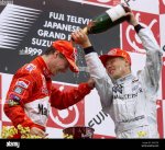 formula-one-drivers-championship-winner-mika-hakkinen-r-douses-briton-eddie-irvine-with-champa...jpg